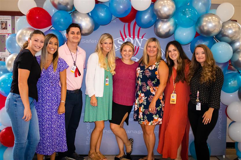 A group of teachers smile